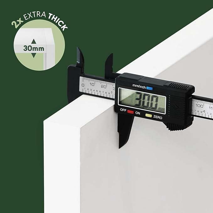 Digital caliper measuring a 30mm thickness on a white surface with a green background